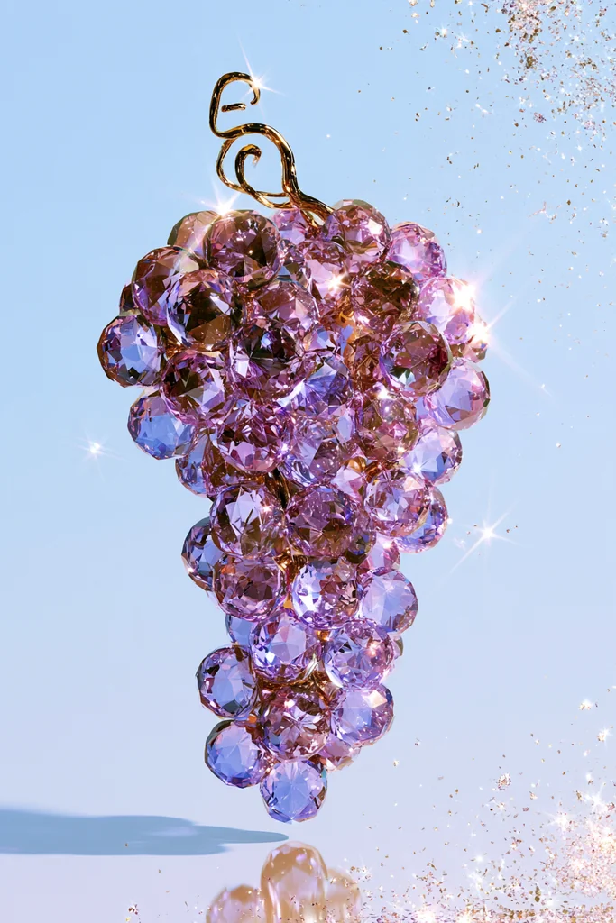 A bunch of purple grapes made of sparkling crystals floating on sky blue with glitter dust