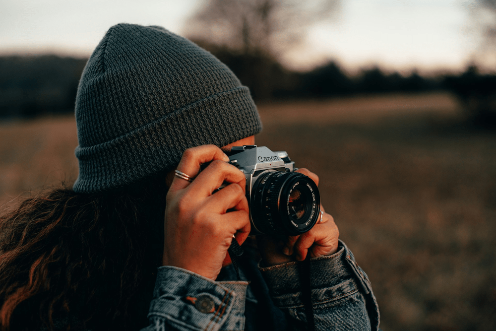 Adventurous Photographer in Nature with Vintage Camera