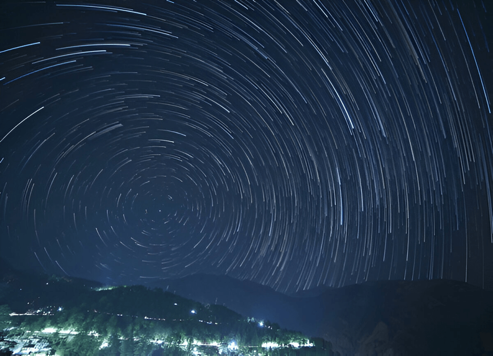 Star Trails Over Mountain Landscape