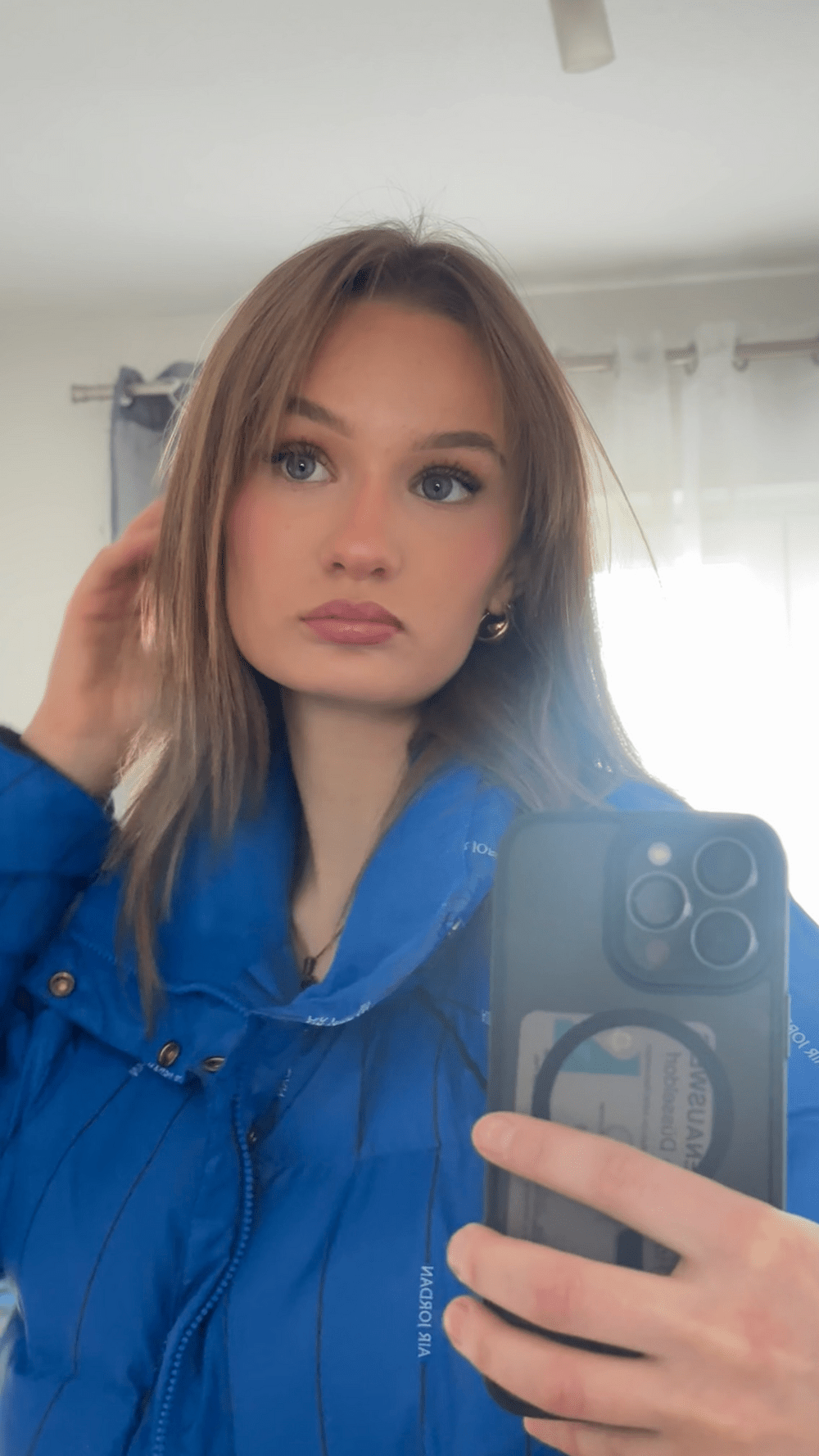 a woman taking a selfie in a mirror