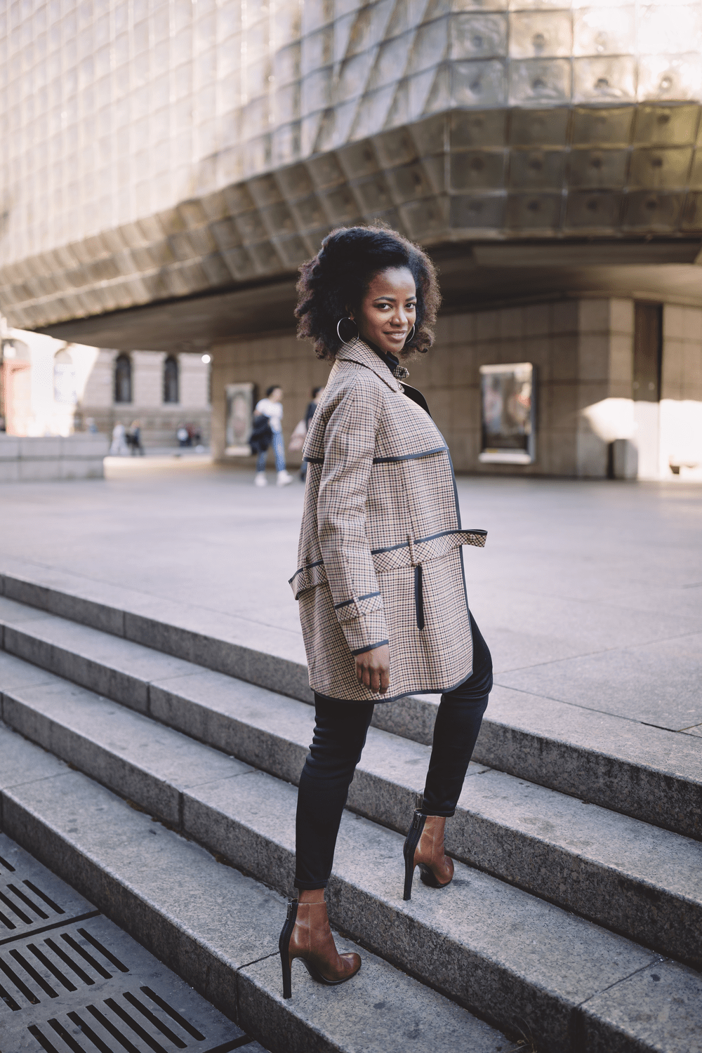 Confident Woman in Stylish Outerwear on Urban Steps