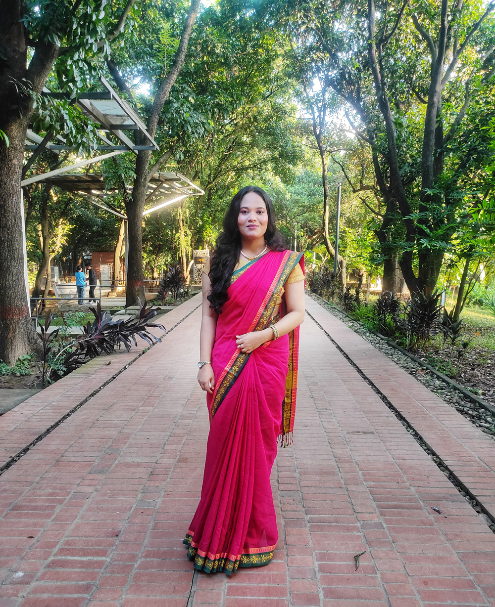 Elegant Woman in Traditional Saree Walking in a Green Park