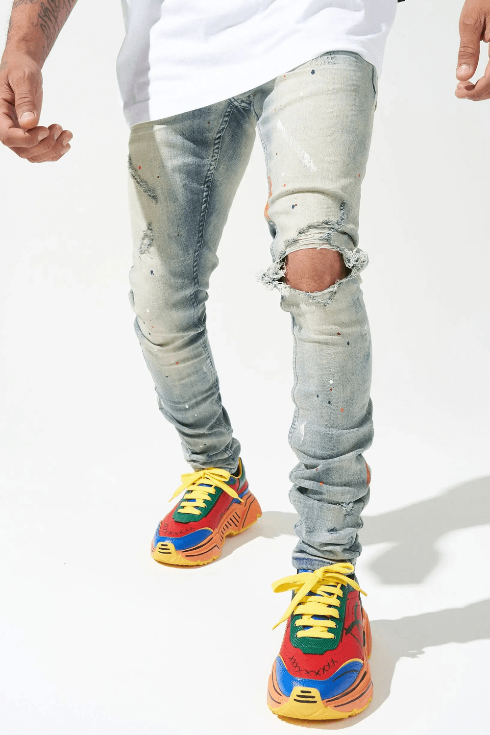 Men's Casual Outfit with Ripped Jeans and Colorful Sneakers