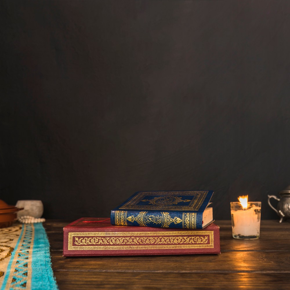 Arabic books near candle