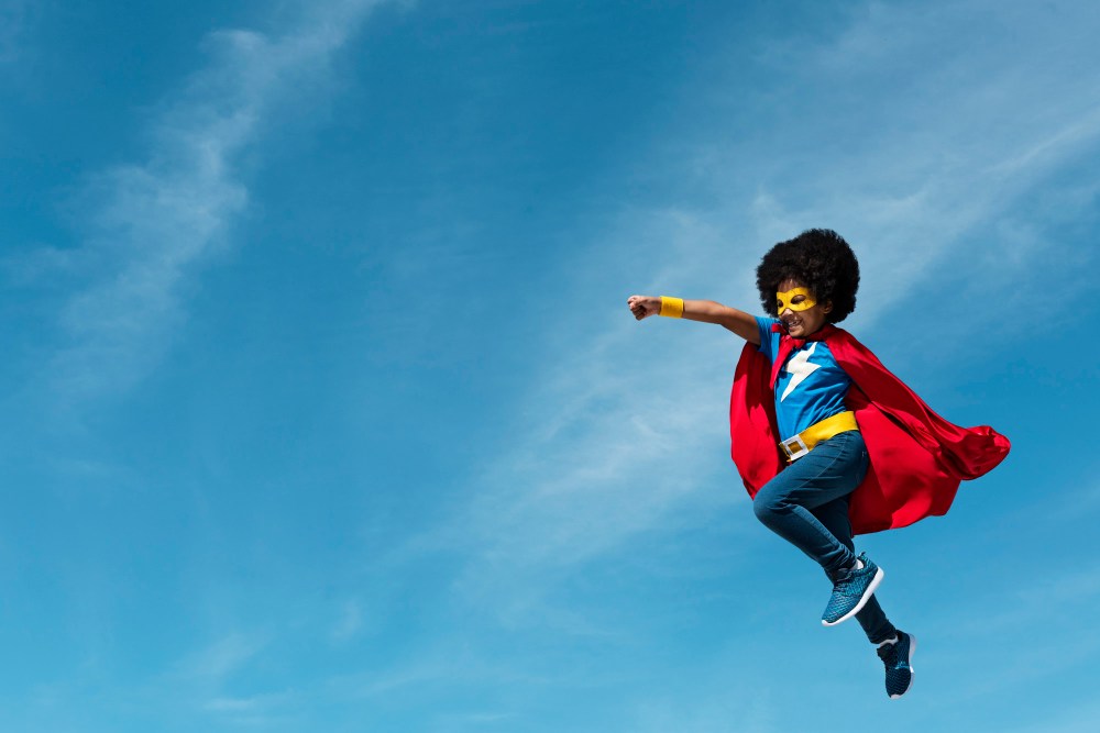 Girl with afro playing superhero