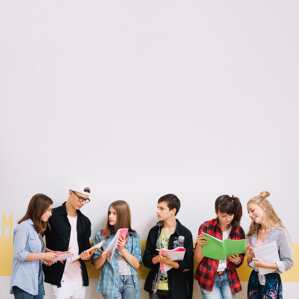 Girls and boys studying at wall