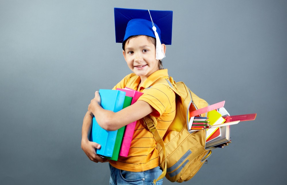 Happy student with his backpack and books
