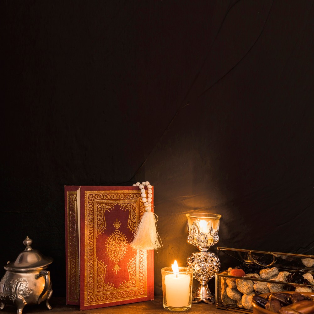 Quran and candles near sweet