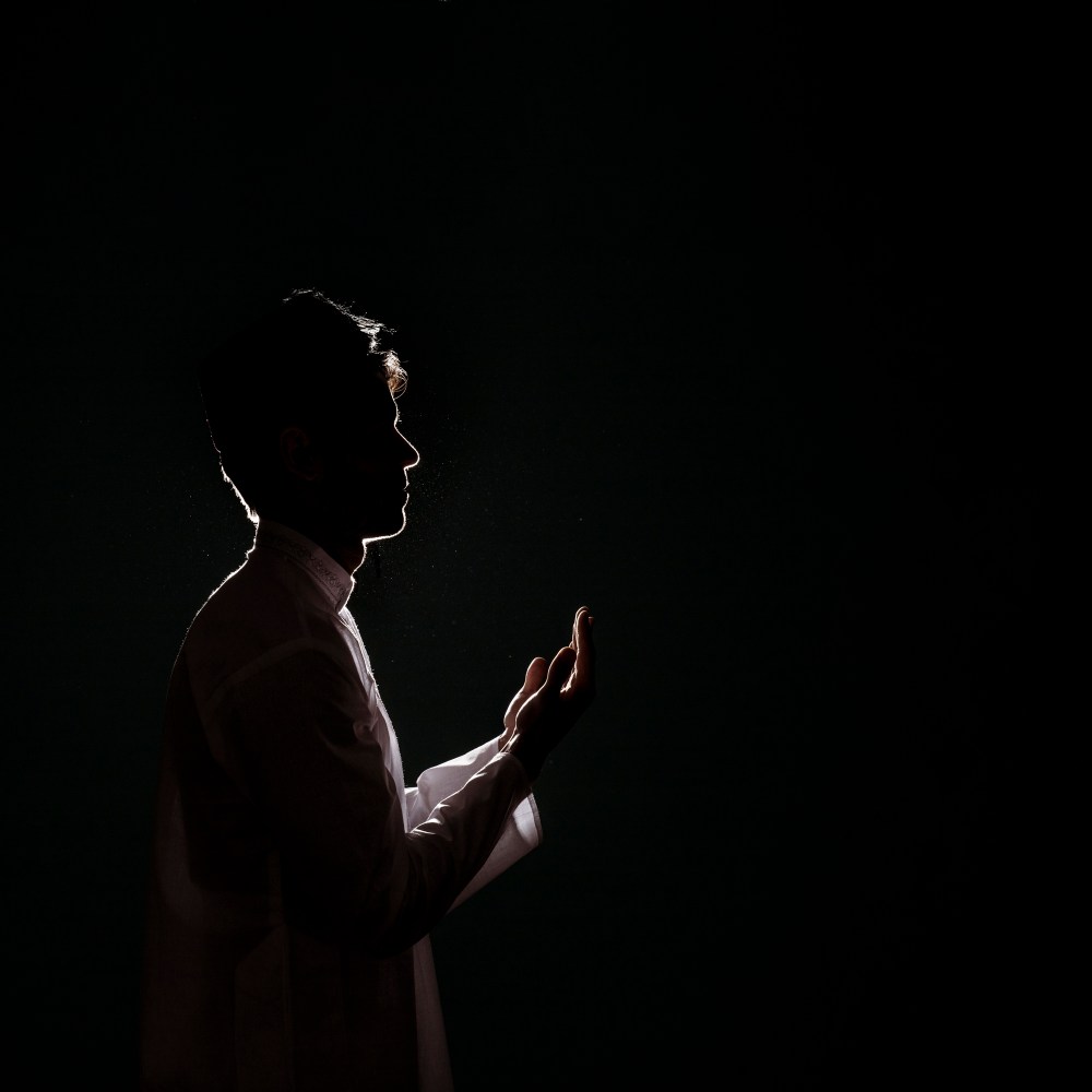 Silhouette of muslim man praying