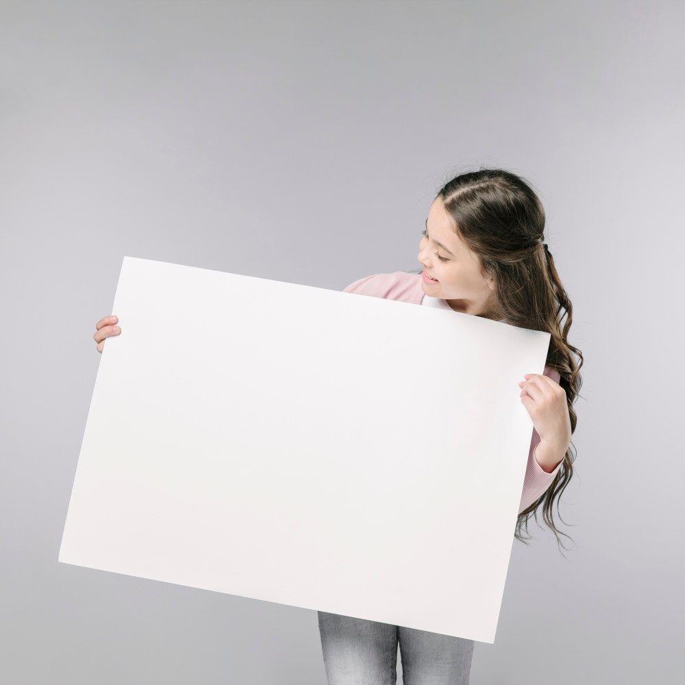 Young girl holding empty banner