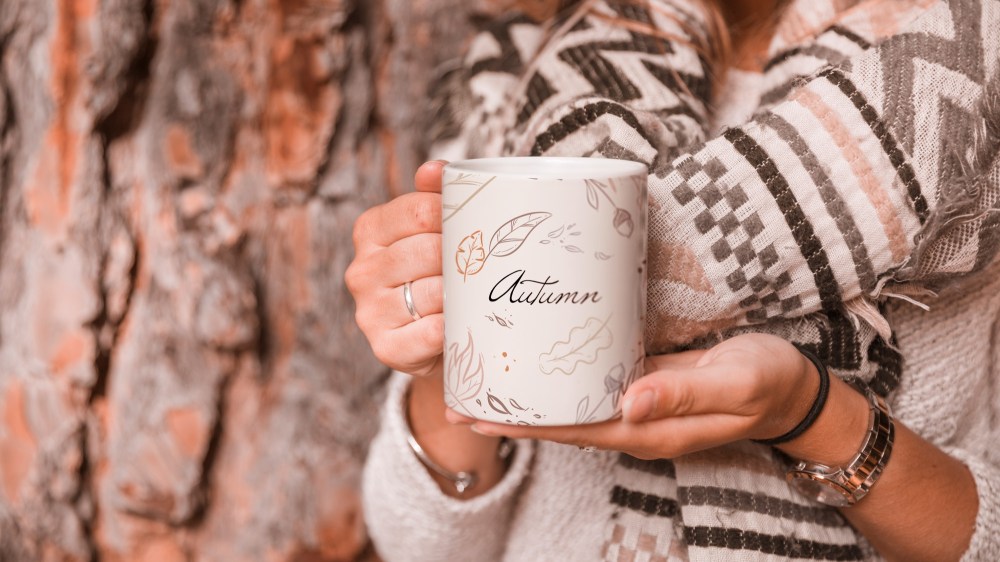 Autumn concept with woman holding mug