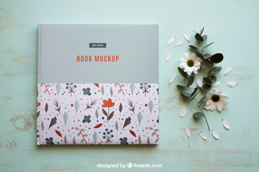 Book mockup next to flowers