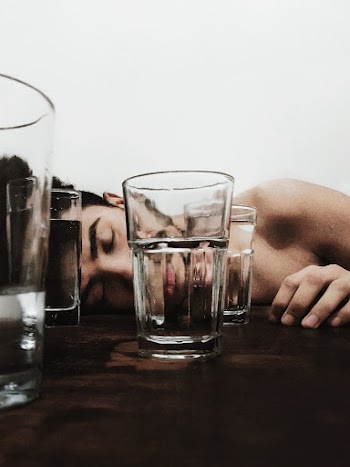 2 Clear Drinking Glasses on Brown Wooden Table