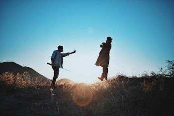2 Man Standing on Mountain during Day Time