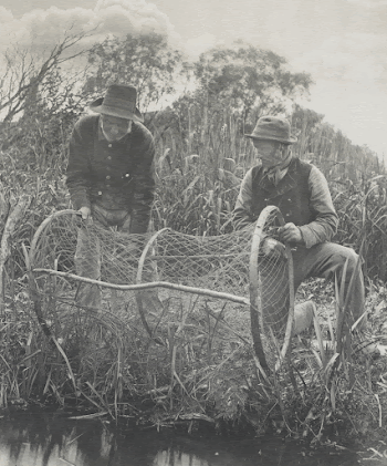 2 men working on a cylindrical-shaped | Free Photo - rawpixel