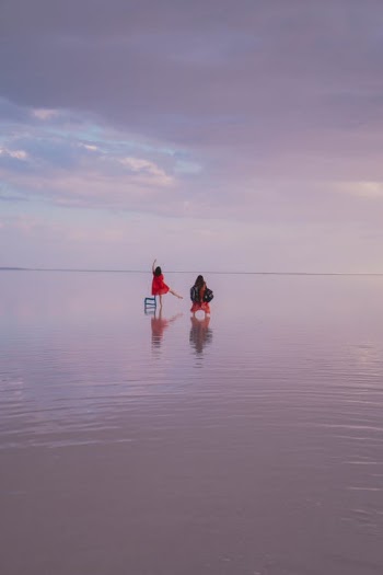 2 Person in Red and Black Wet Suit on Water · Free Stock Photo
