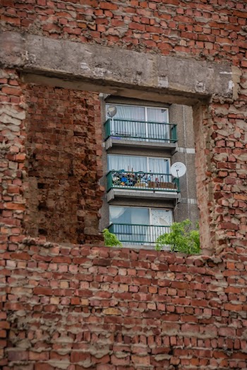 3-panel Windows With Fences on Red Brick Building