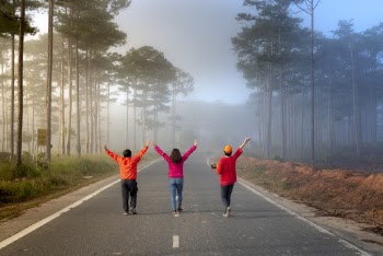 3 People Walking in the Middle of the Street