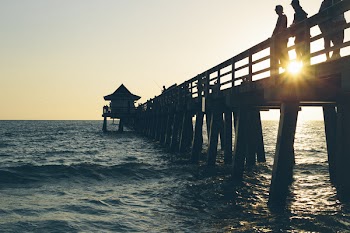 3 Person Standing on Pier