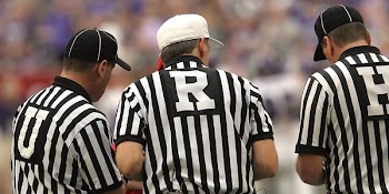 3 Referees Standing on Field