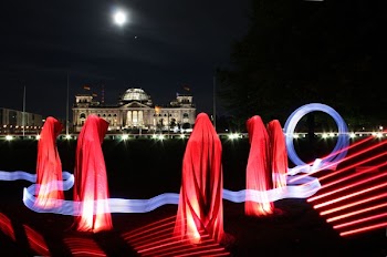 5 People Hiding Under Red Textile during Night