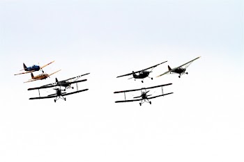 7 Biplane Flying on Air Under Clouds during Daytime