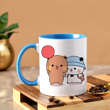 a blue and white coffee mug sitting on top of a wooden tray next to a banana and a potted plant
