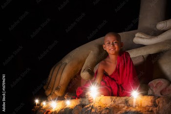 A boy in buddhism set fire with candle in bagan