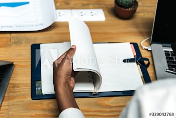 A businesswoman checking her notes in a notebook