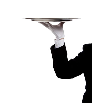 a butler's gloved hand holding a silver tray on a white background with copy space