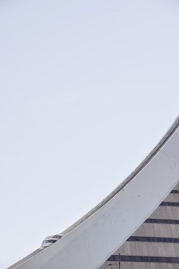 A cable car on a concrete structure with a curving slope