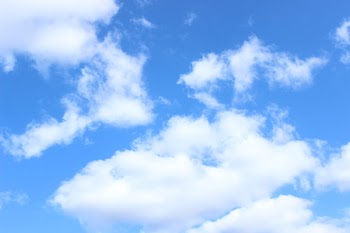A cloud of white clouds floating in the sky.