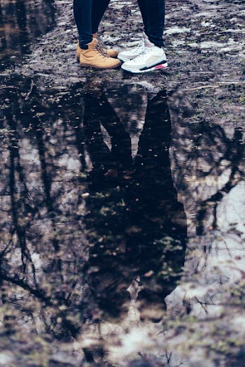 A couple reflection in a puddle