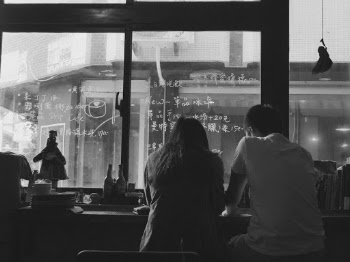 A couple, sitting in taiwaneese coffee spot. 