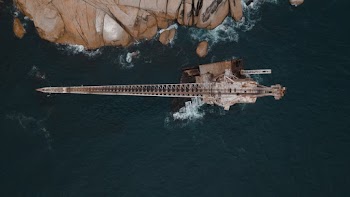 A Crane On A Rock Formation At Sea