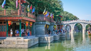 A Crowd Of People Visiting A Tourist Destination By The River