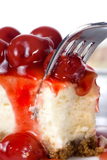 A delicious slice of cheesecake with fruit topping.
