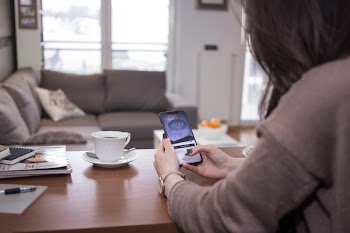 A female holding an iPhone X 2