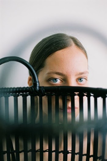 A Female Looking at Camera Behind an Obstacle  · Free Stock Photo