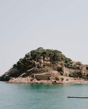 A Fortress In A Small Rocky Island With Lush Vegetation