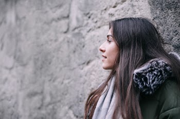 A girl leaning against a wall