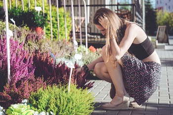 A girl looking at flowers