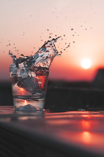 A Glass of Water and a Red Sun