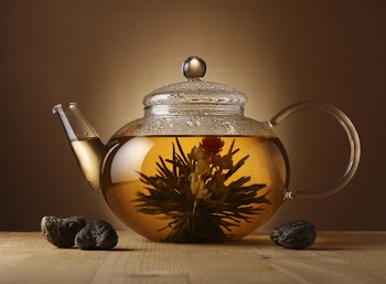 A glass teapot with Lotus Flower Chinese tea.