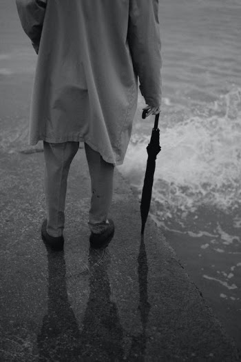 A Grayscale of a Person Holding an Umbrella · Free Stock Photo