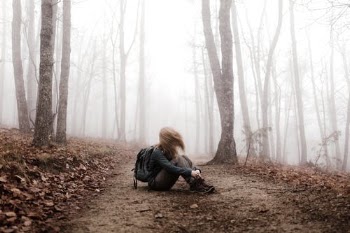 A Hiker Sitting on a Path in the Woods · Free Stock Photo