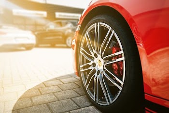 A hubcap on a red car.