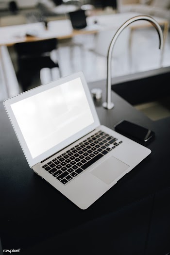 A laptop on a black counter | Free stock psd mockup - 488419