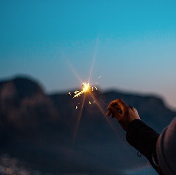 A Lit Flare Light On Hand