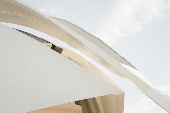 A long arch at the edge of a modern white facade